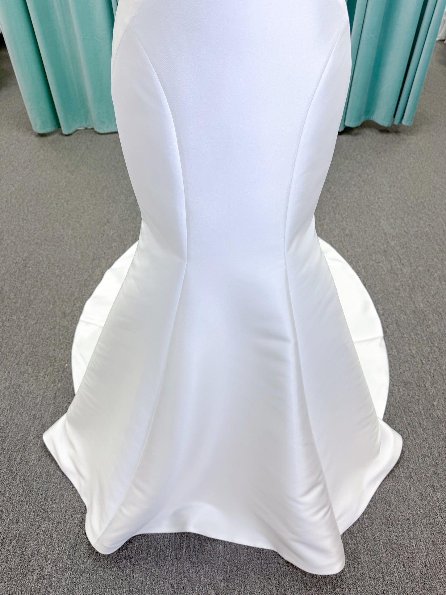 Randy Fenoli Imani fit and flare wedding dress on mannequin with strapless sweetheart neckline, structured mikado bodice, and oversized back bow with covered buttons