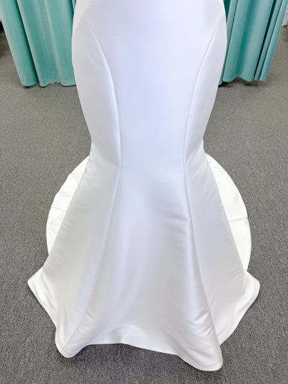 Randy Fenoli Imani fit and flare wedding dress on mannequin with strapless sweetheart neckline, structured mikado bodice, and oversized back bow with covered buttons