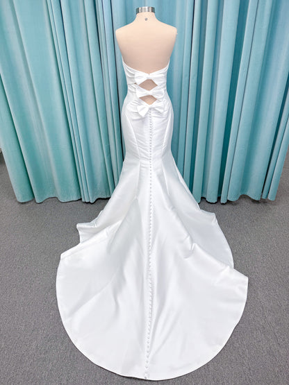 Randy Fenoli Imani fit and flare wedding dress on mannequin with strapless sweetheart neckline, structured mikado bodice, and oversized back bow with covered buttons