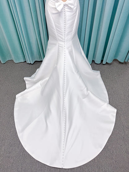 Randy Fenoli Imani fit and flare wedding dress on mannequin with strapless sweetheart neckline, structured mikado bodice, and oversized back bow with covered buttons