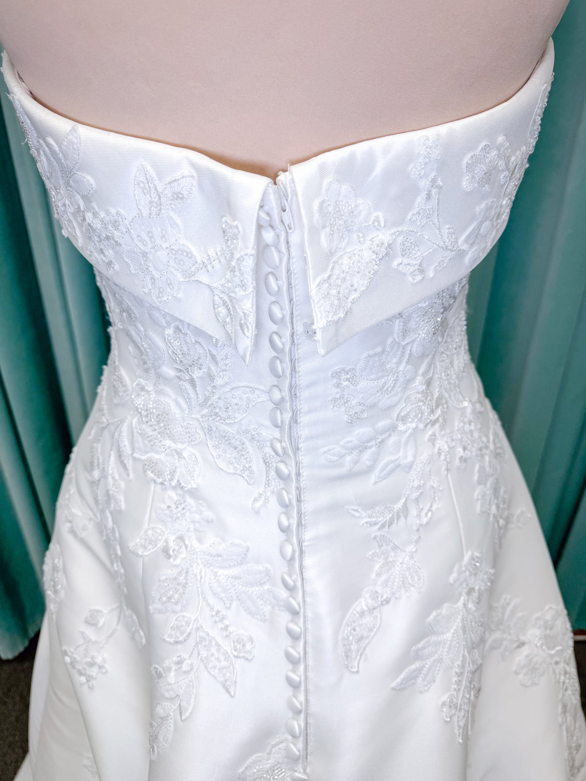 Morilee 1010037 Isadora A-line wedding dress on mannequin with strapless cuffed neckline, princess seams, and beaded Mikado lace