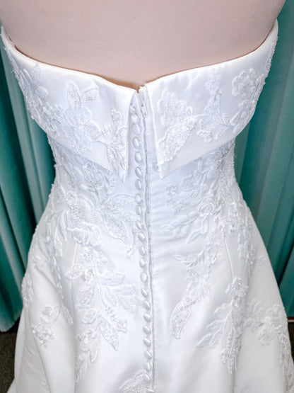Morilee 1010037 Isadora A-line wedding dress on mannequin with strapless cuffed neckline, princess seams, and beaded Mikado lace