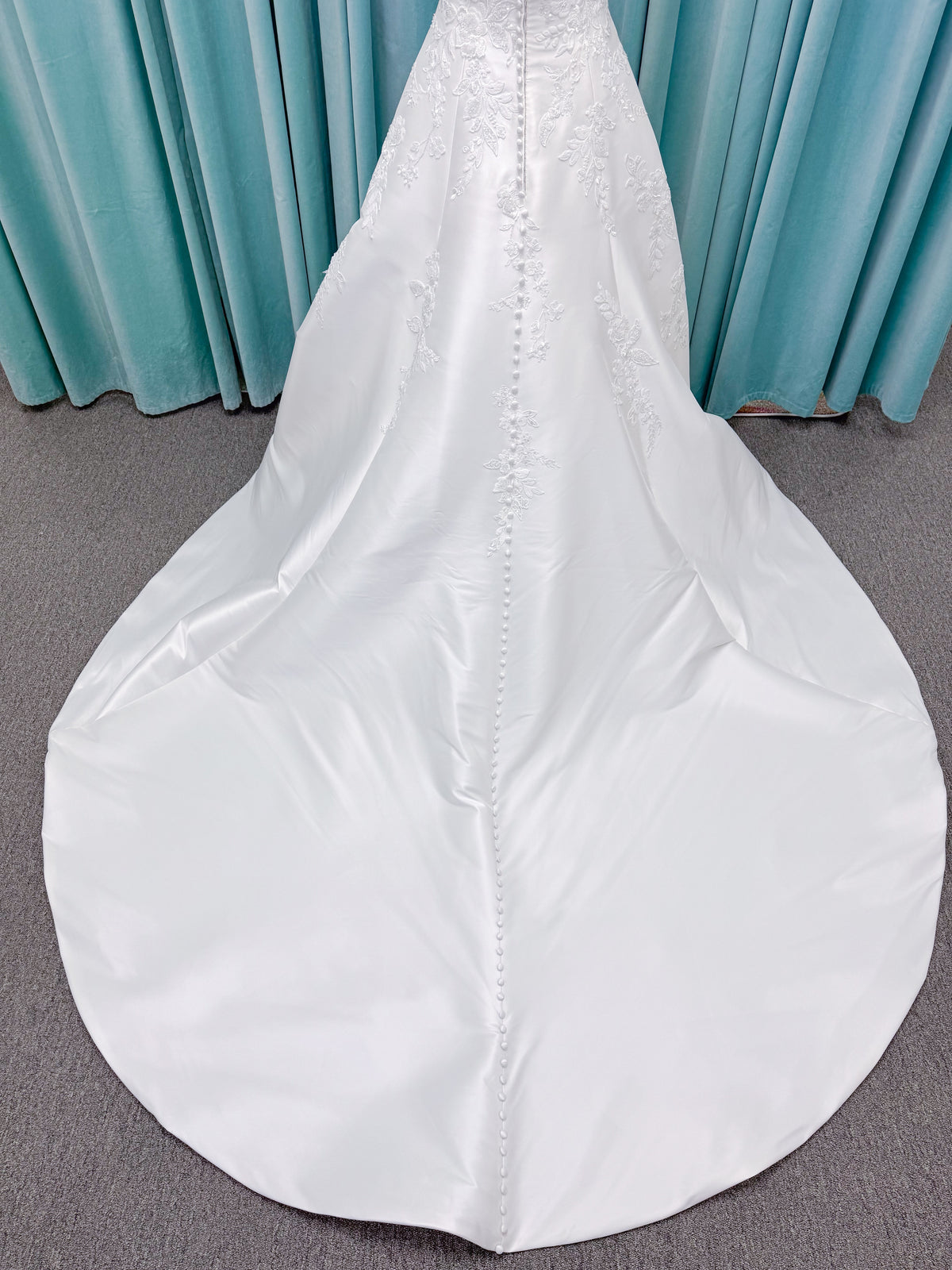 Morilee 1010037 Isadora A-line wedding dress on mannequin with strapless cuffed neckline, princess seams, and beaded Mikado lace