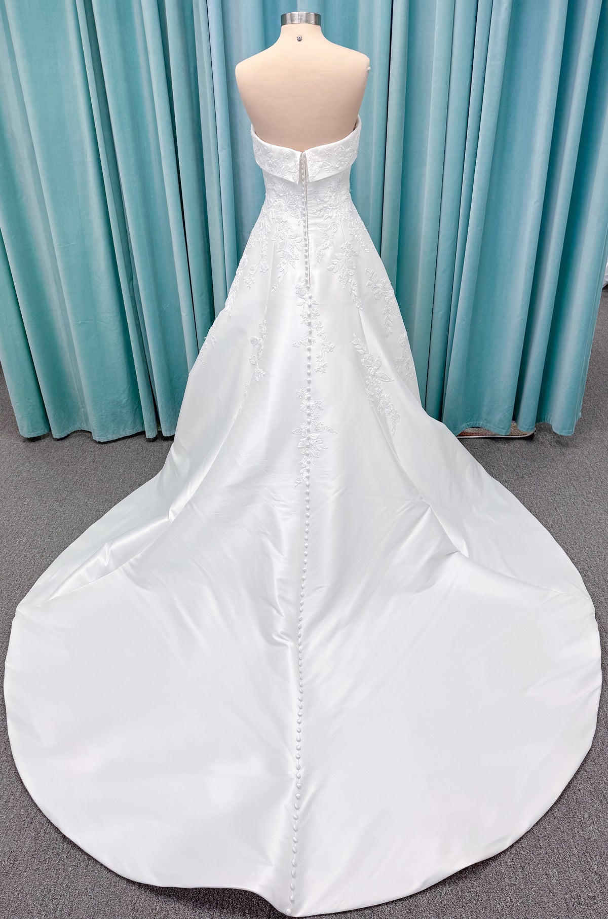 Morilee 1010037 Isadora A-line wedding dress on mannequin with strapless cuffed neckline, princess seams, and beaded Mikado lace