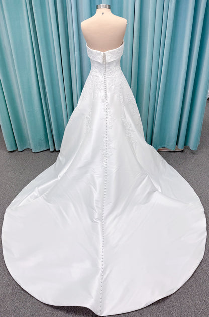 Morilee 1010037 Isadora A-line wedding dress on mannequin with strapless cuffed neckline, princess seams, and beaded Mikado lace