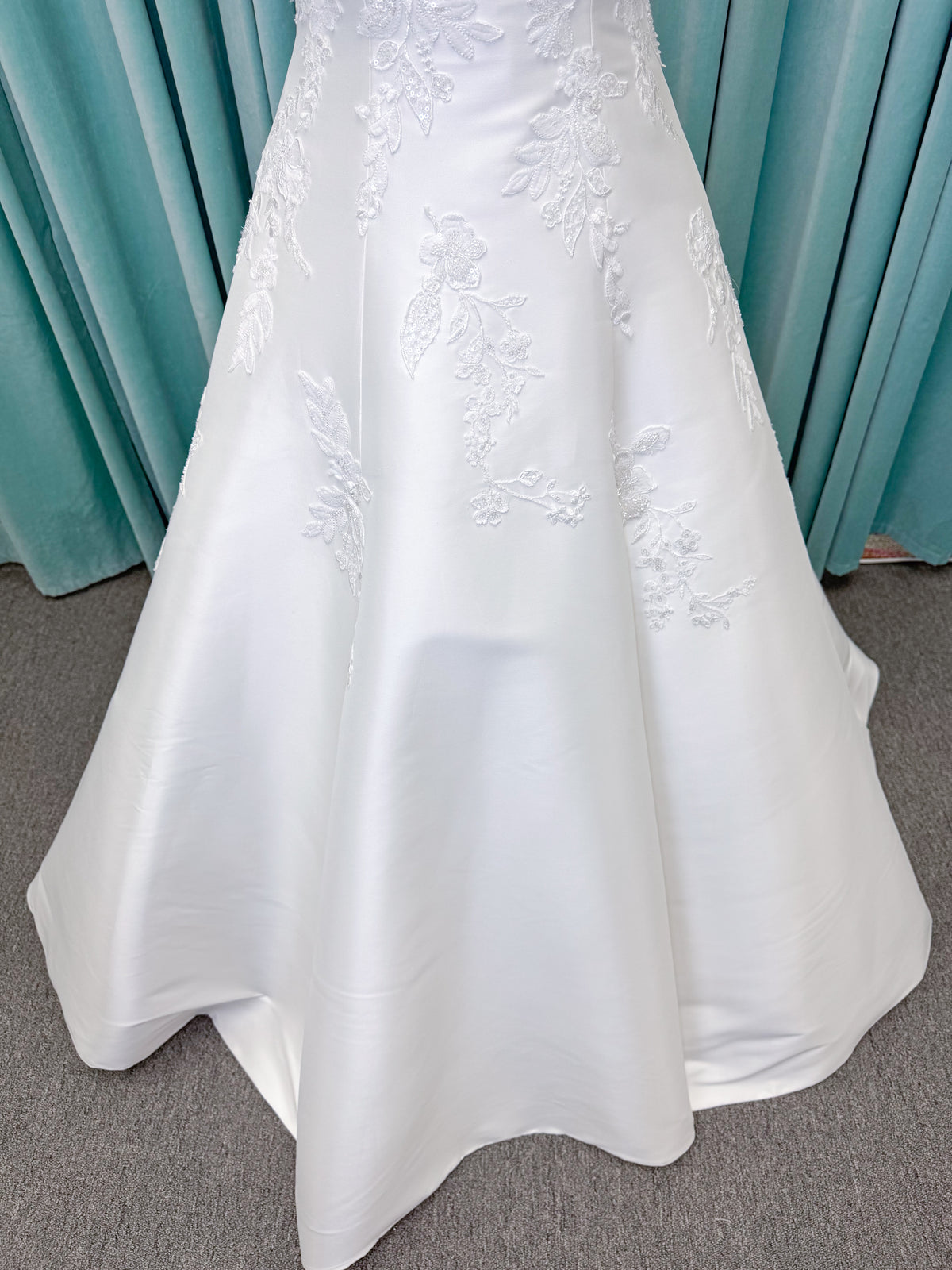 Morilee 1010037 Isadora A-line wedding dress on mannequin with strapless cuffed neckline, princess seams, and beaded Mikado lace