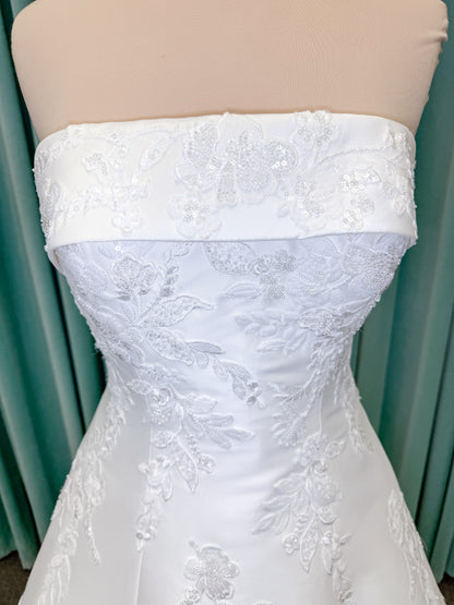 Morilee 1010037 Isadora A-line wedding dress on mannequin with strapless cuffed neckline, princess seams, and beaded Mikado lace