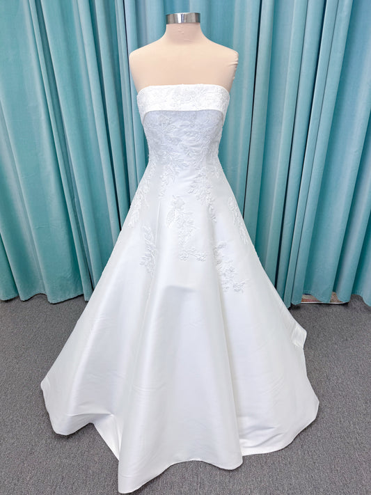 Morilee 1010037 Isadora A-line wedding dress on mannequin with strapless cuffed neckline, princess seams, and beaded Mikado lace