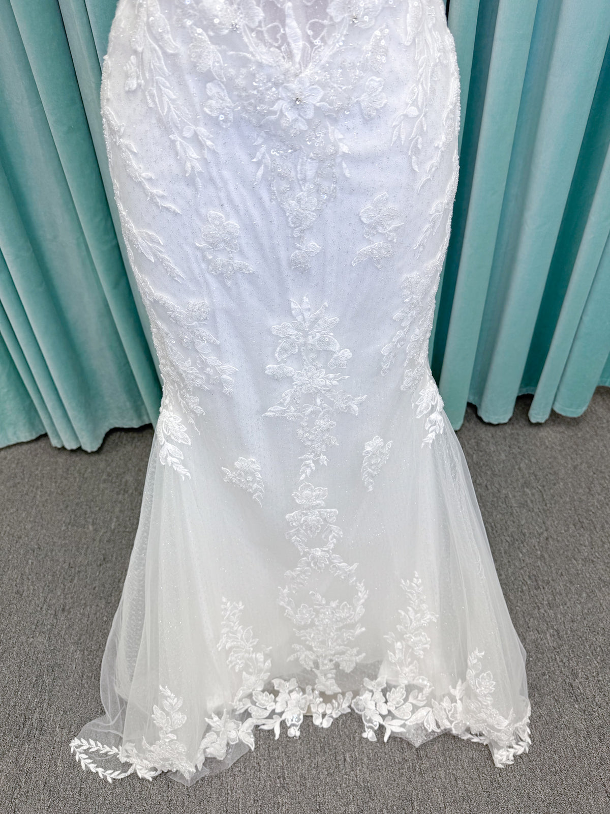 Randy Fenoli Jillian fit and flare wedding dress on mannequin with strapless sweetheart neckline, beaded lace appliqué, detachable off-the-shoulder straps, and glitter tulle skirt