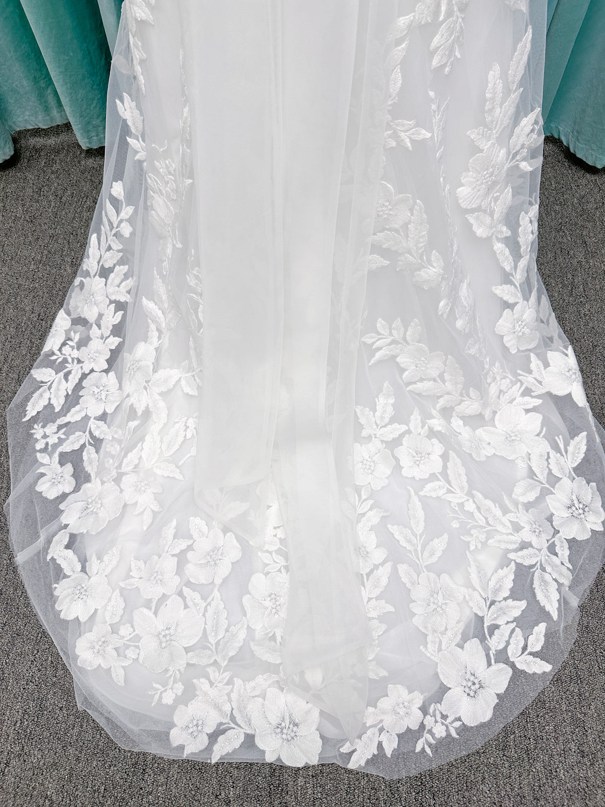 Morilee 2936 Kali fit and flare wedding dress on mannequin with high neckline, threadwork floral appliqued tulle, and detachable organza bow blouson sleeves