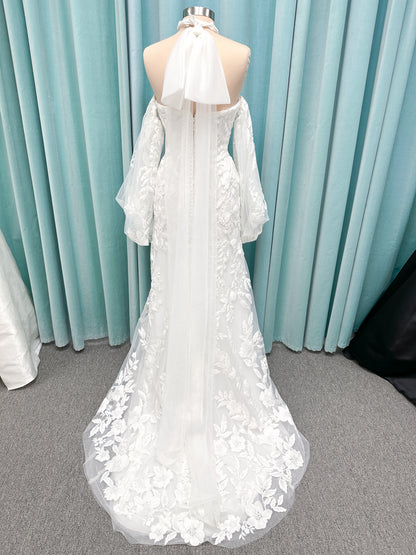 Morilee 2936 Kali fit and flare wedding dress on mannequin with high neckline, threadwork floral appliqued tulle, and detachable organza bow blouson sleeves