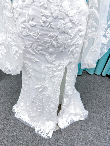 Morilee 2936 Kali fit and flare wedding dress on mannequin with high neckline, threadwork floral appliqued tulle, and detachable organza bow blouson sleeves
