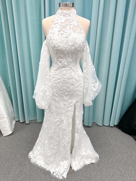Morilee 2936 Kali fit and flare wedding dress on mannequin with high neckline, threadwork floral appliqued tulle, and detachable organza bow blouson sleeves