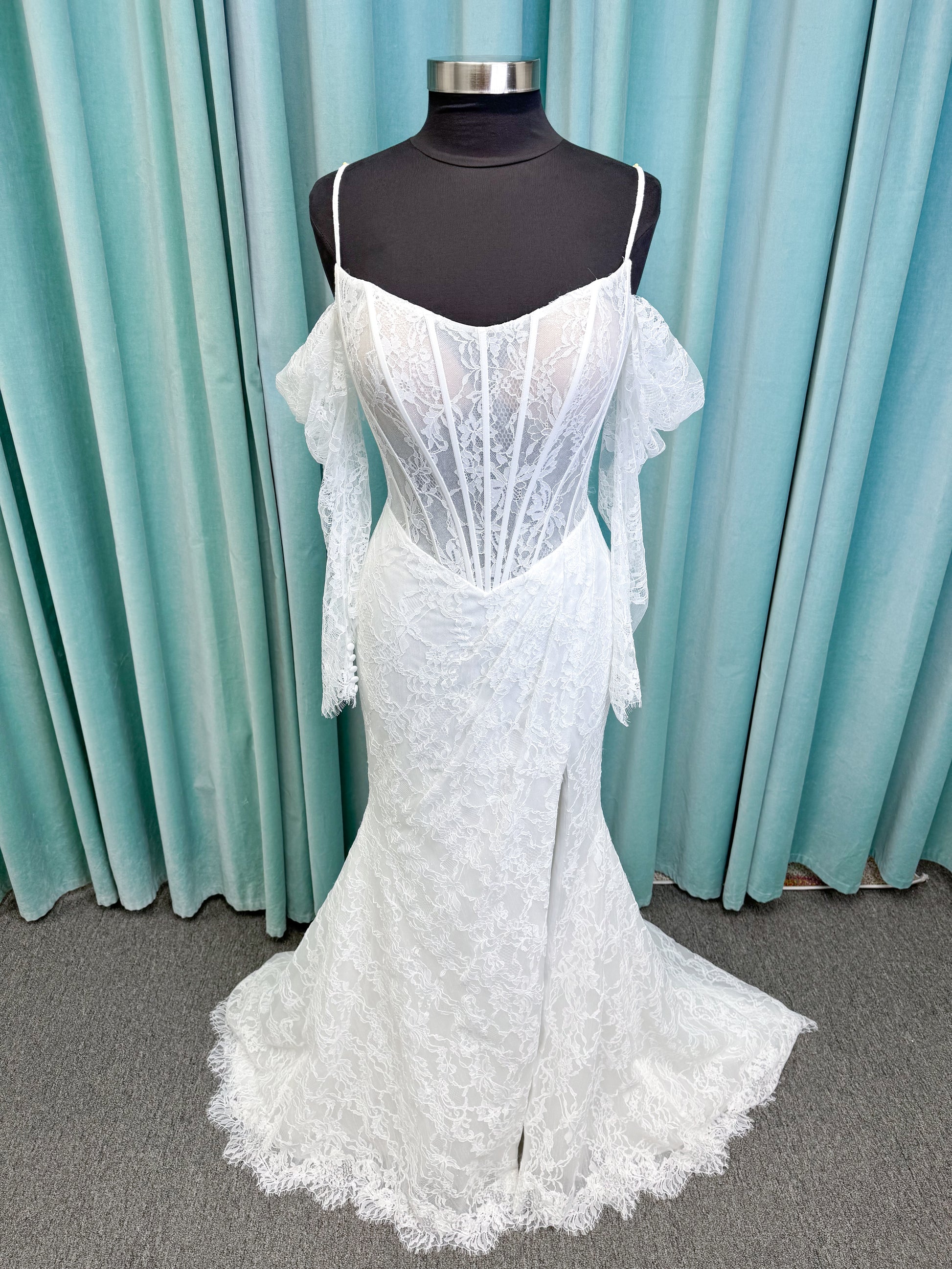 Morilee 2983 Leto fit and flare wedding dress with scoop neckline, lace corset bodice, glitter tulle, detachable draped sleeves, thigh-high slit, and sweeping train.