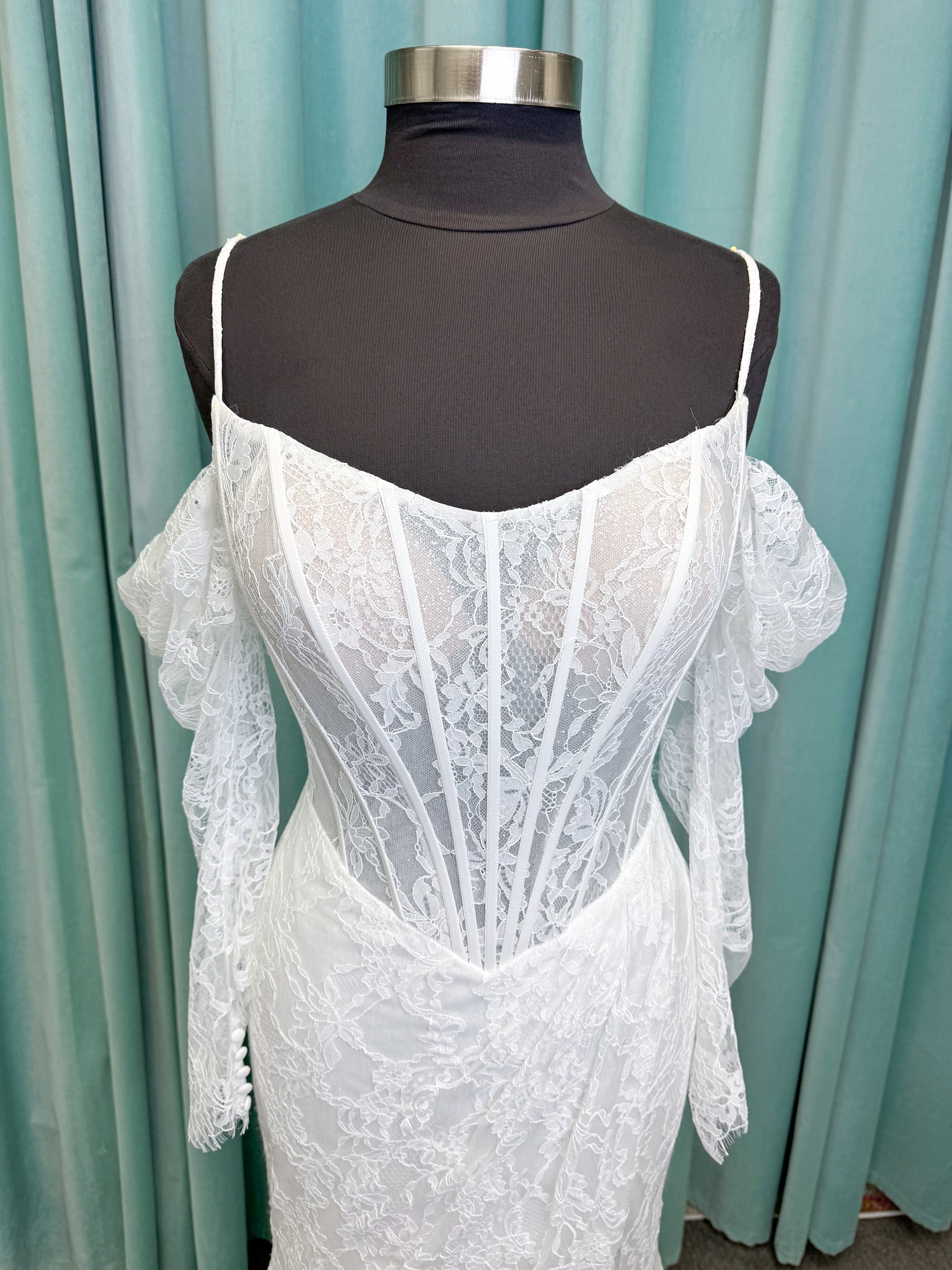 Morilee 2983 Leto fit and flare wedding dress with scoop neckline, lace corset bodice, glitter tulle, detachable draped sleeves, thigh-high slit, and sweeping train.