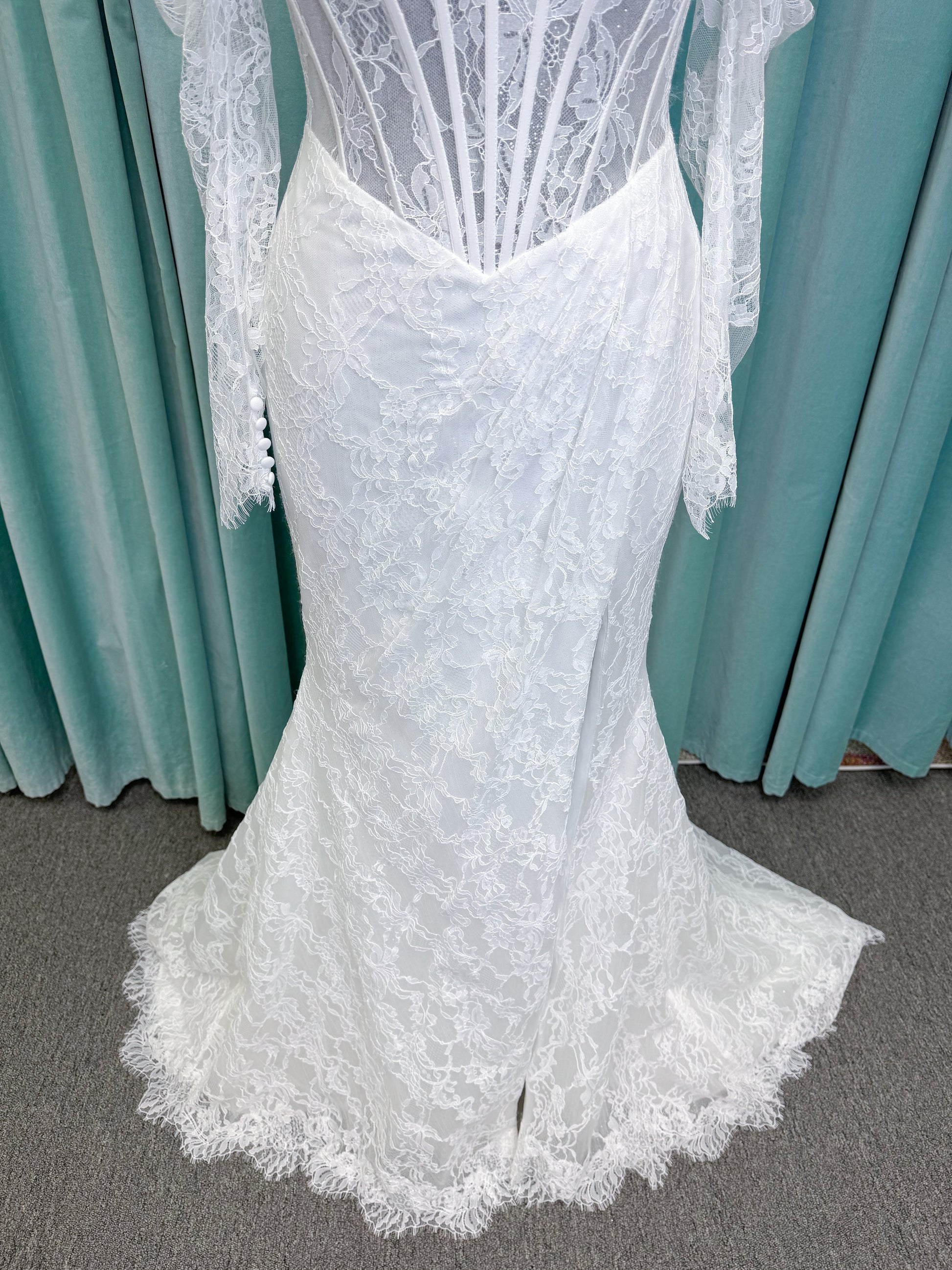 Morilee 2983 Leto fit and flare wedding dress with scoop neckline, lace corset bodice, glitter tulle, detachable draped sleeves, thigh-high slit, and sweeping train.