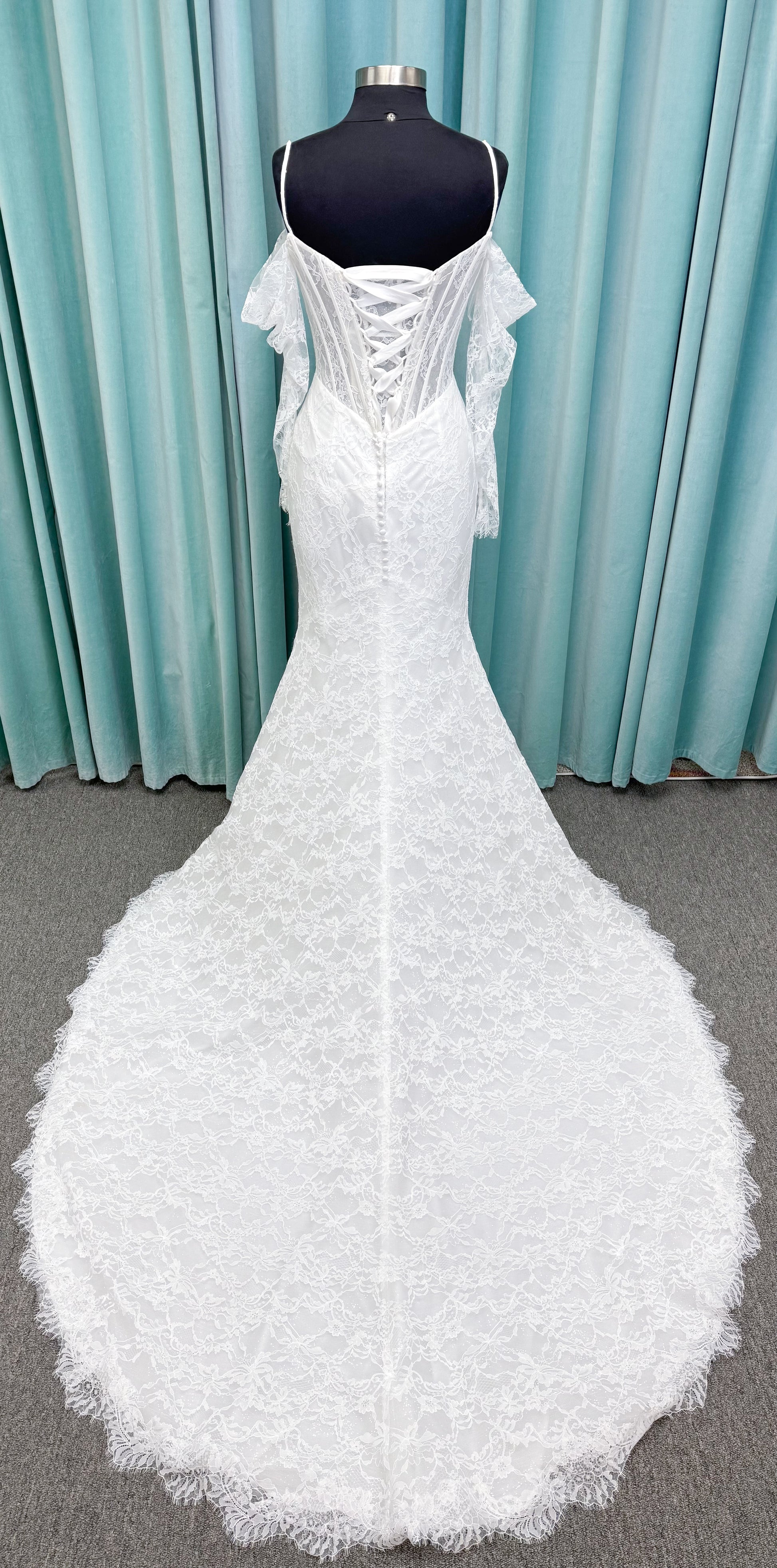 Morilee 2983 Leto fit and flare wedding dress with scoop neckline, lace corset bodice, glitter tulle, detachable draped sleeves, thigh-high slit, and sweeping train.