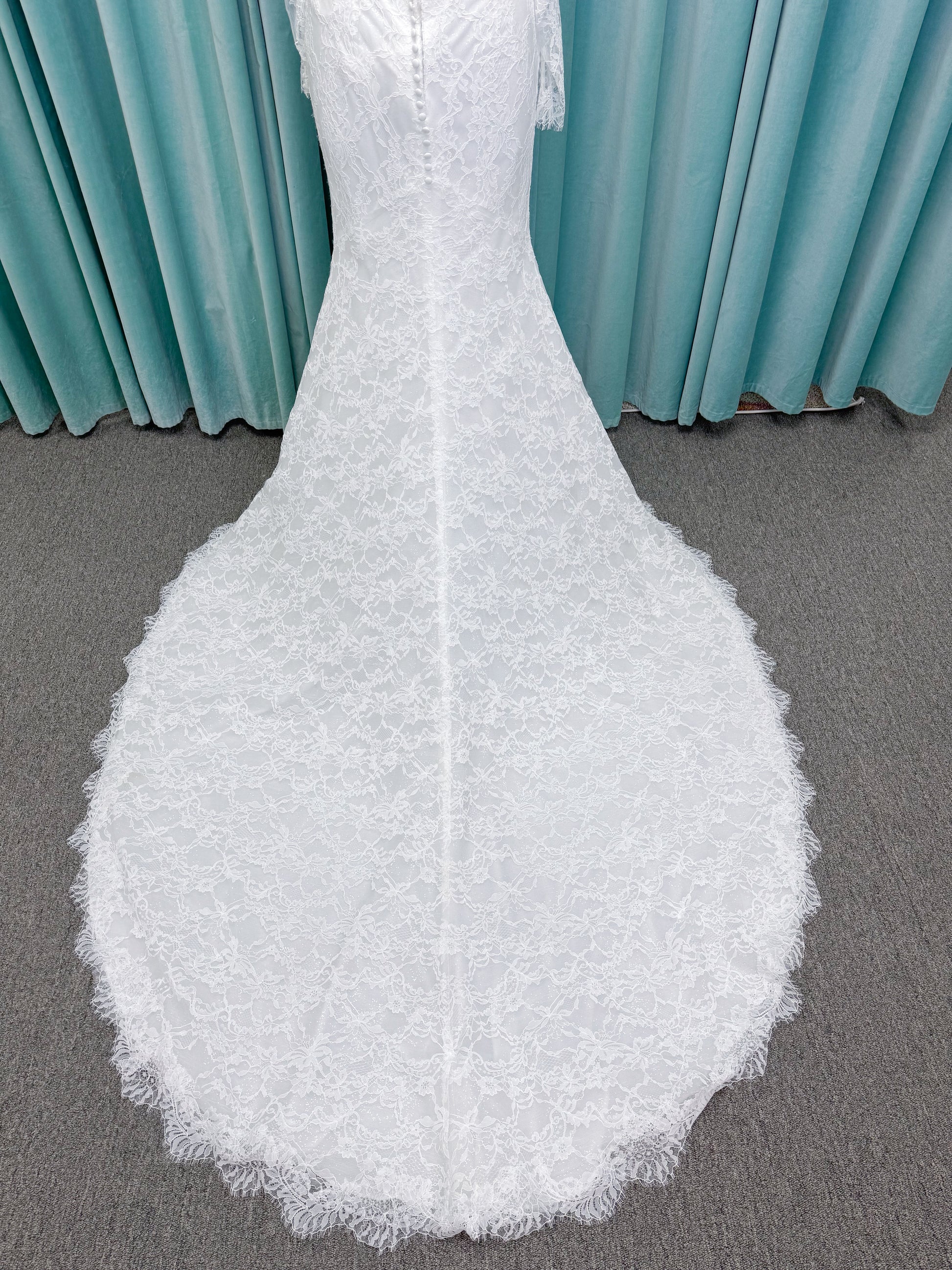 Morilee 2983 Leto fit and flare wedding dress with scoop neckline, lace corset bodice, glitter tulle, detachable draped sleeves, thigh-high slit, and sweeping train.