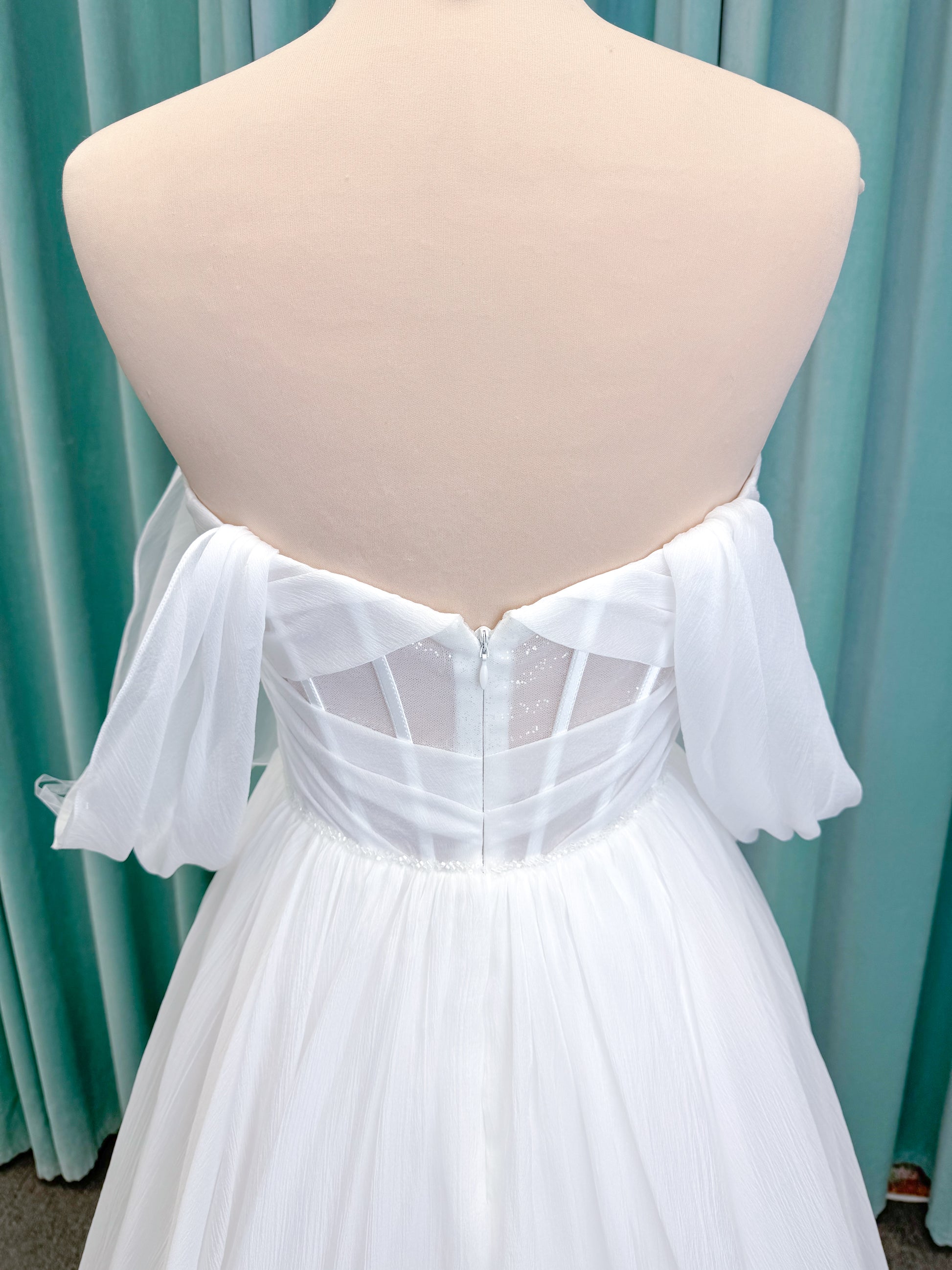 Morilee 2910L Levana A-line wedding dress on mannequin with sweetheart strapless neckline, off-the-shoulder sleeves, draped organza bodice, and beaded waistband