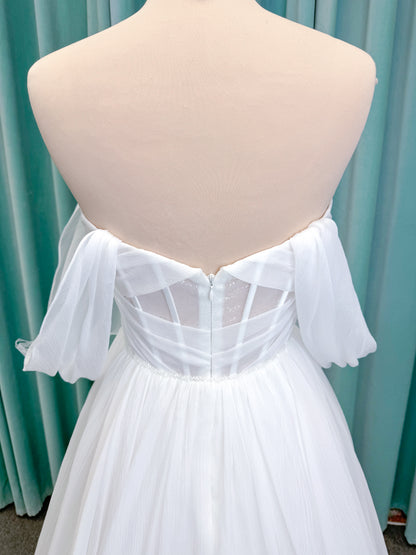 Morilee 2910L Levana A-line wedding dress on mannequin with sweetheart strapless neckline, off-the-shoulder sleeves, draped organza bodice, and beaded waistband
