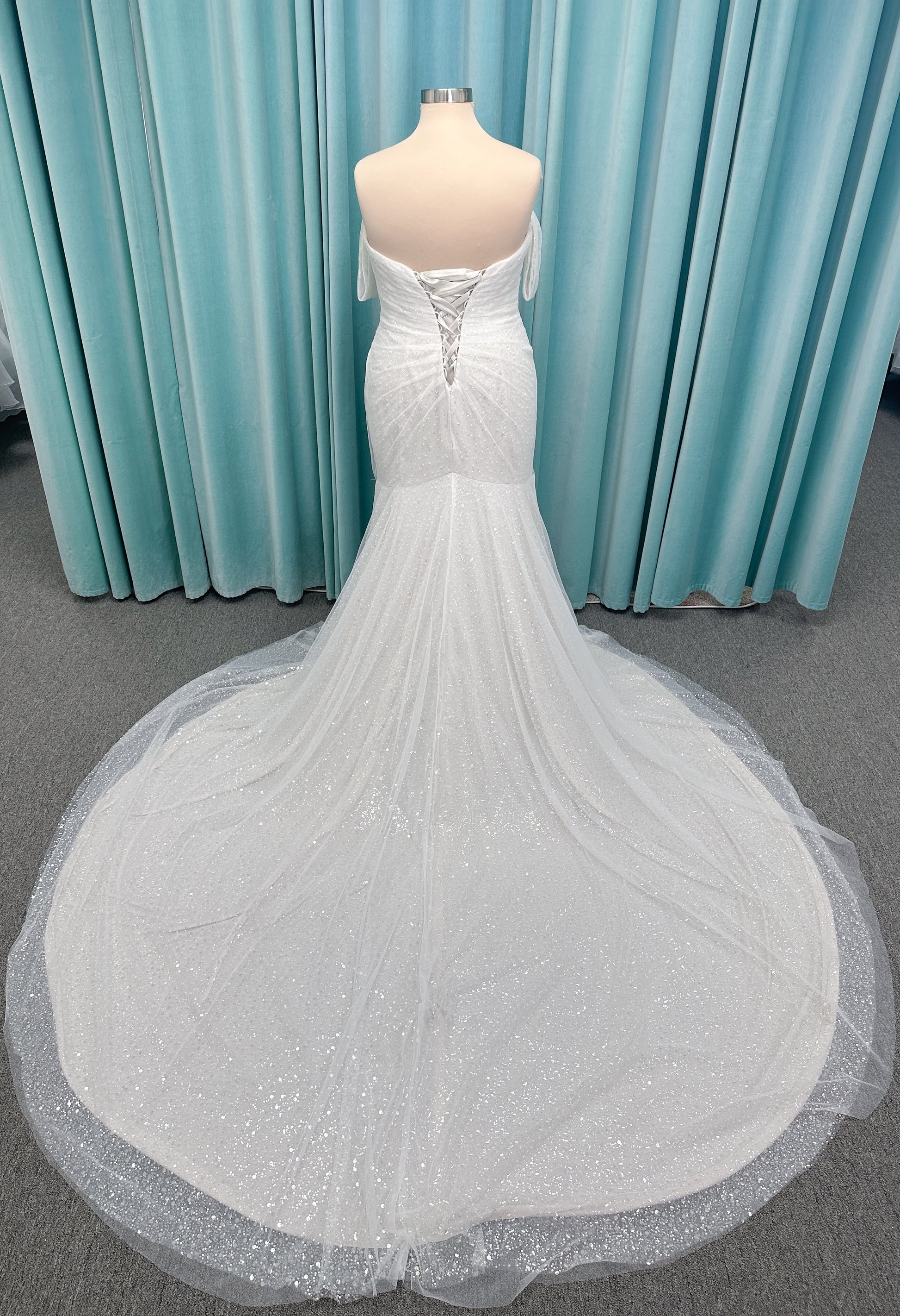 Morilee 3393 Lyrica fit and flare wedding dress in allover beaded net with draped tulle overlay, lace-up corset back, and detachable draped sleeves.