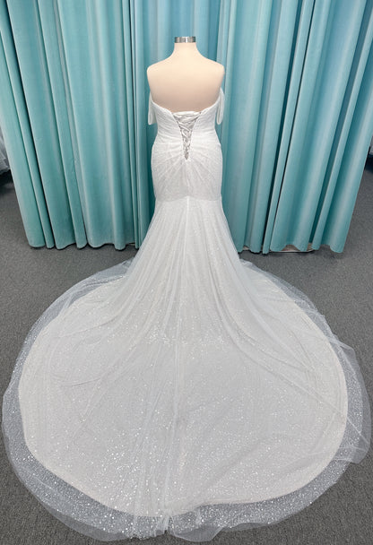 Morilee 3393 Lyrica fit and flare wedding dress in allover beaded net with draped tulle overlay, lace-up corset back, and detachable draped sleeves.