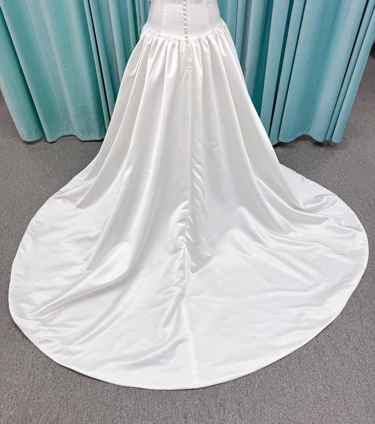 Moonlight Bridal J6956 Mahina ballgown wedding dress on mannequin with scoop neckline, detachable off-the-shoulder swag sleeves, drop waist, ruched shimmering satin skirt, and chapel train with horsehair hem