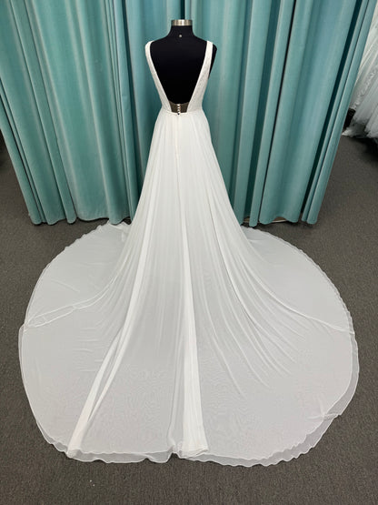Martha My Dear ivory sleeveless V-neck A-line wedding dress on mannequin with geometric lace bodice panel and flowing chiffon skirt.
