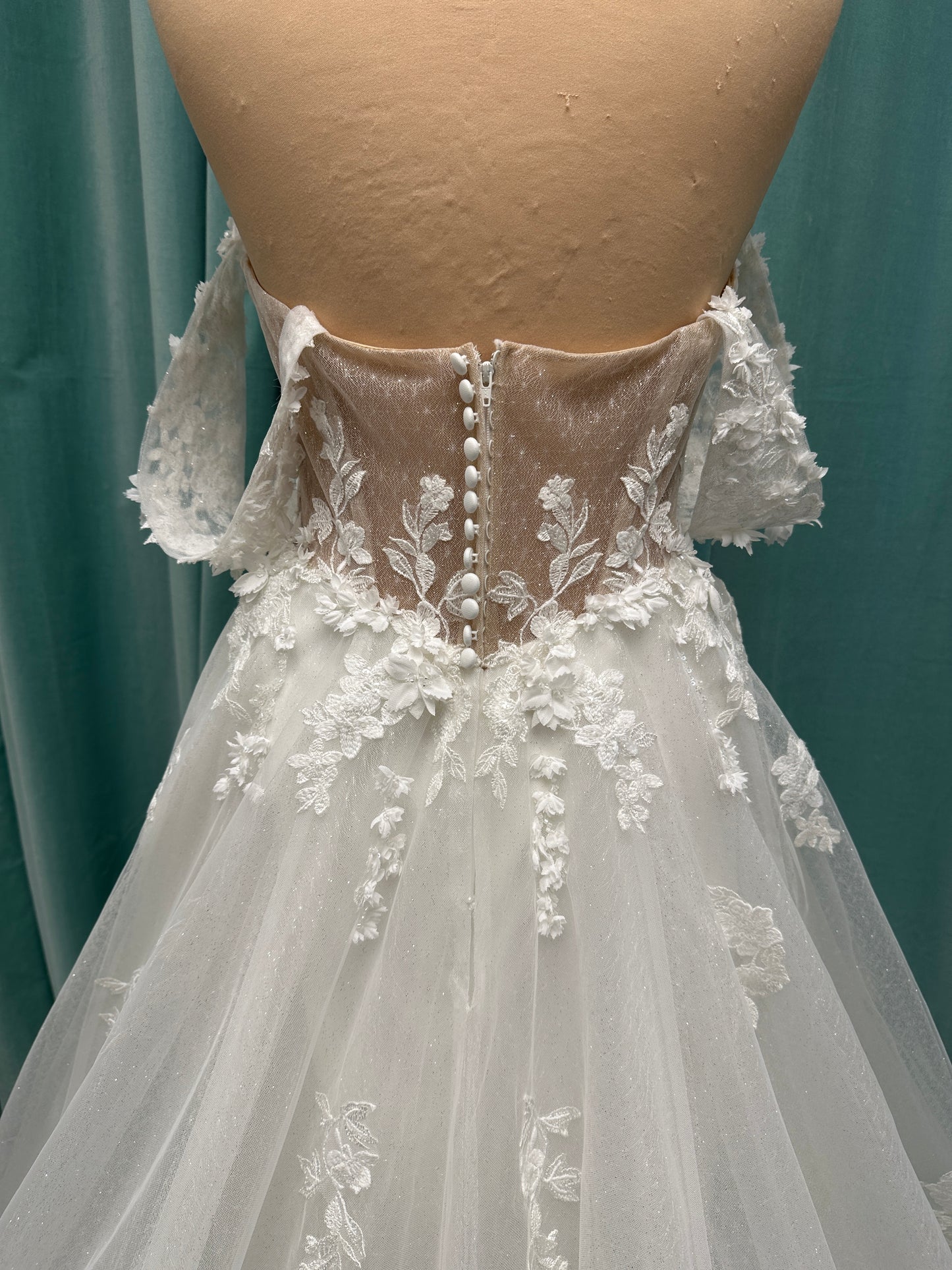 Off-the-shoulder lace A-line wedding dress with corset bodice, 3D floral appliqués, and glitter tulle skirt by Essense of Australia style D4360