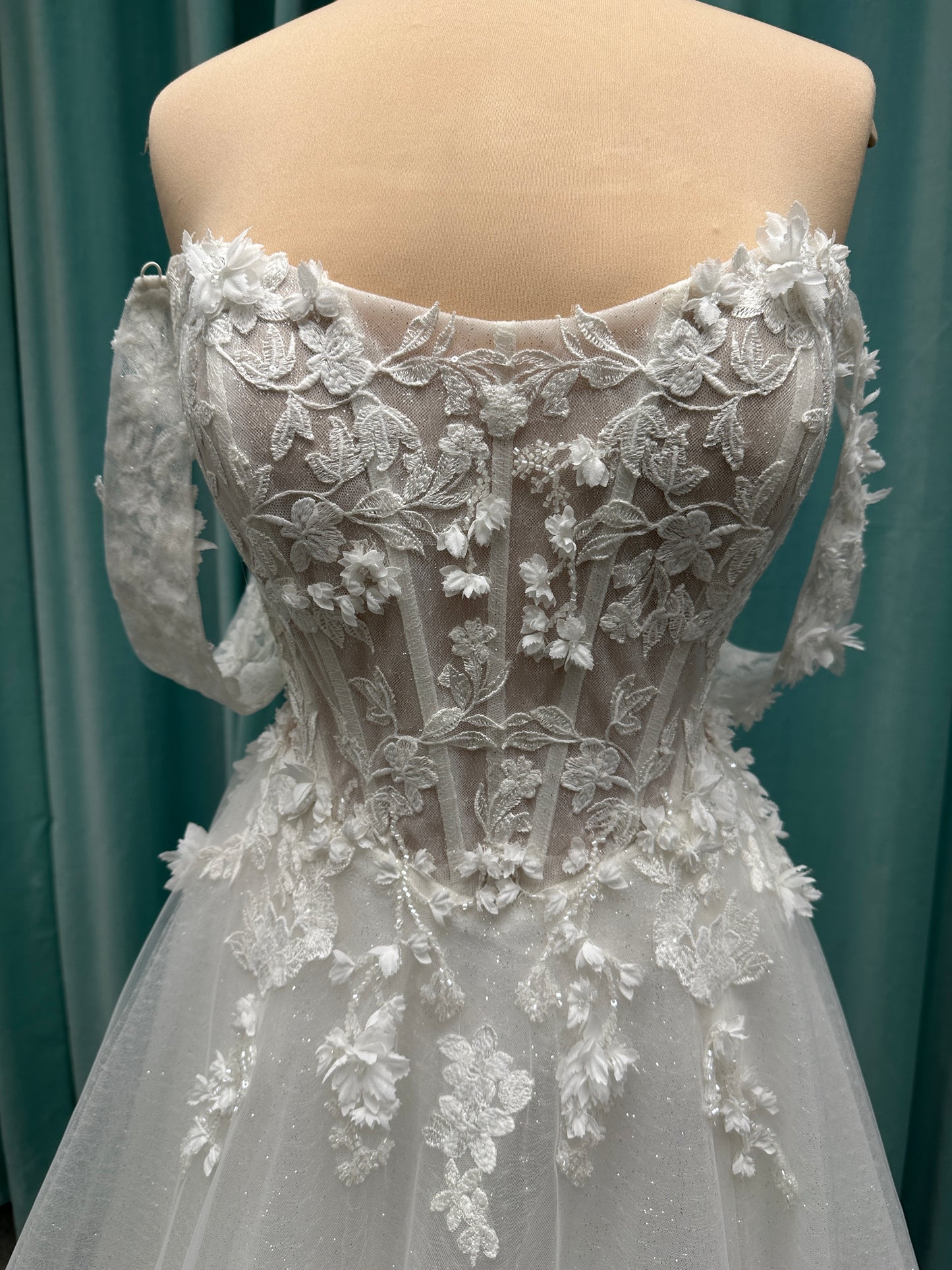 Off-the-shoulder lace A-line wedding dress with corset bodice, 3D floral appliqués, and glitter tulle skirt by Essense of Australia style D4360