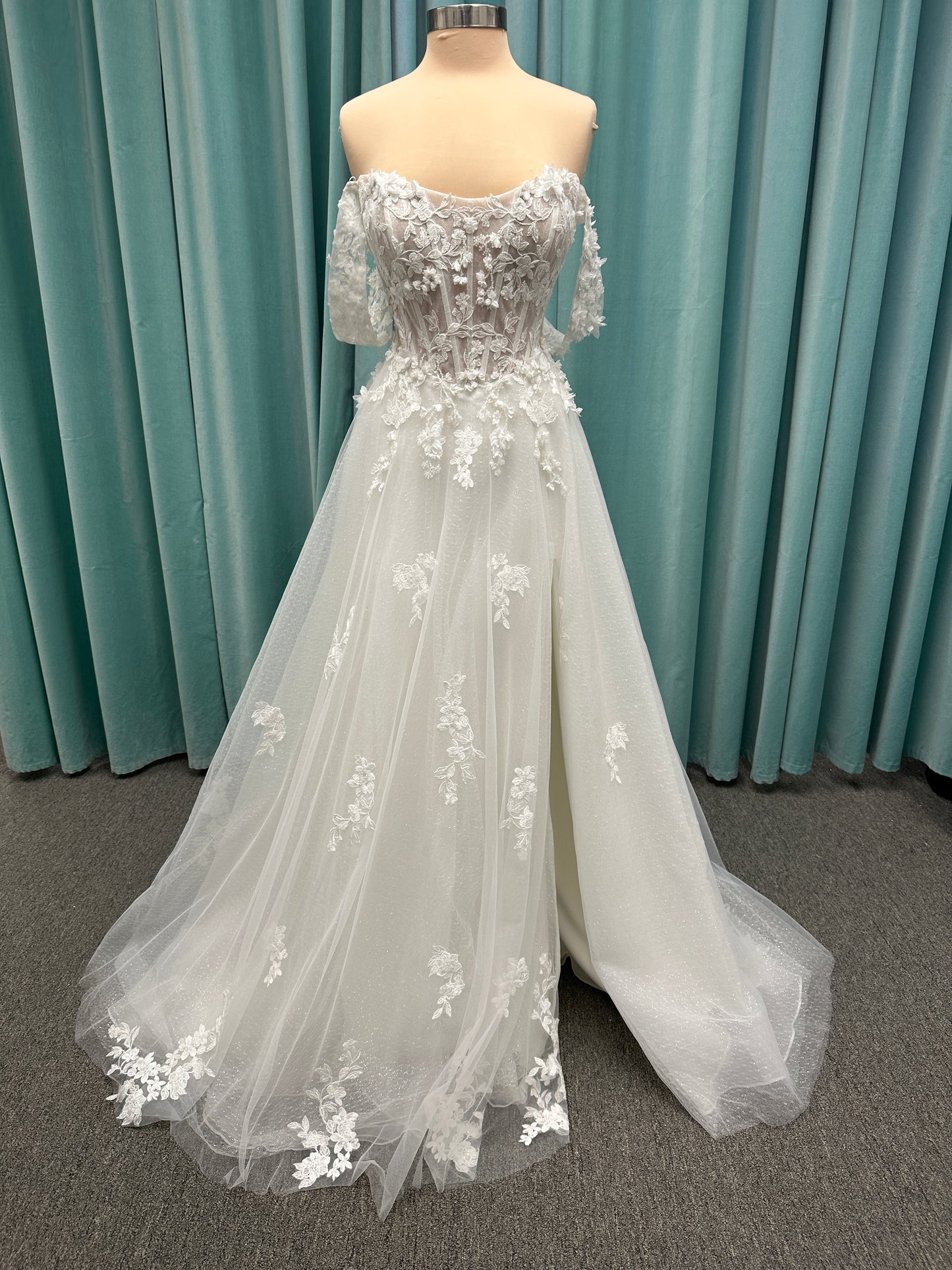 Off-the-shoulder lace A-line wedding dress with corset bodice, 3D floral appliqués, and glitter tulle skirt by Essense of Australia style D4360