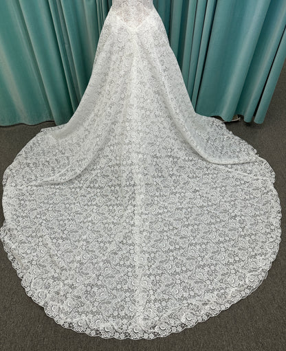 Min ivory strapless sweetheart lace A-line wedding dress on mannequin with illusion corset bodice and voluminous lace skirt.
