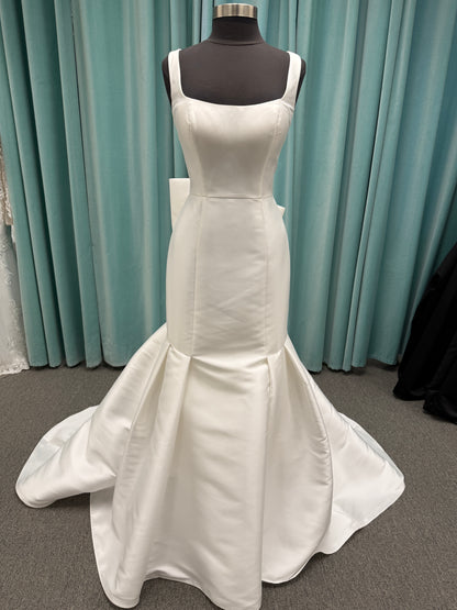 Modest Mikado fit-and-flare wedding dress with square neckline, low scoop back, and dramatic detachable bow train