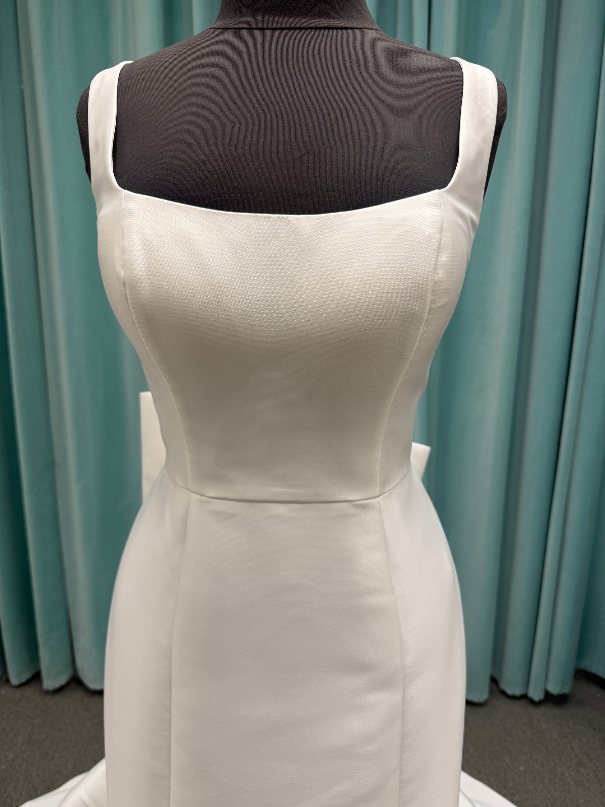 Modest Mikado fit-and-flare wedding dress with square neckline, low scoop back, and dramatic detachable bow train