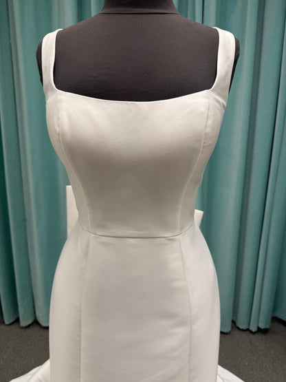 Modest Mikado fit-and-flare wedding dress with square neckline, low scoop back, and dramatic detachable bow train