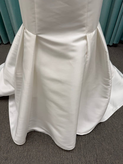 Modest Mikado fit-and-flare wedding dress with square neckline, low scoop back, and dramatic detachable bow train