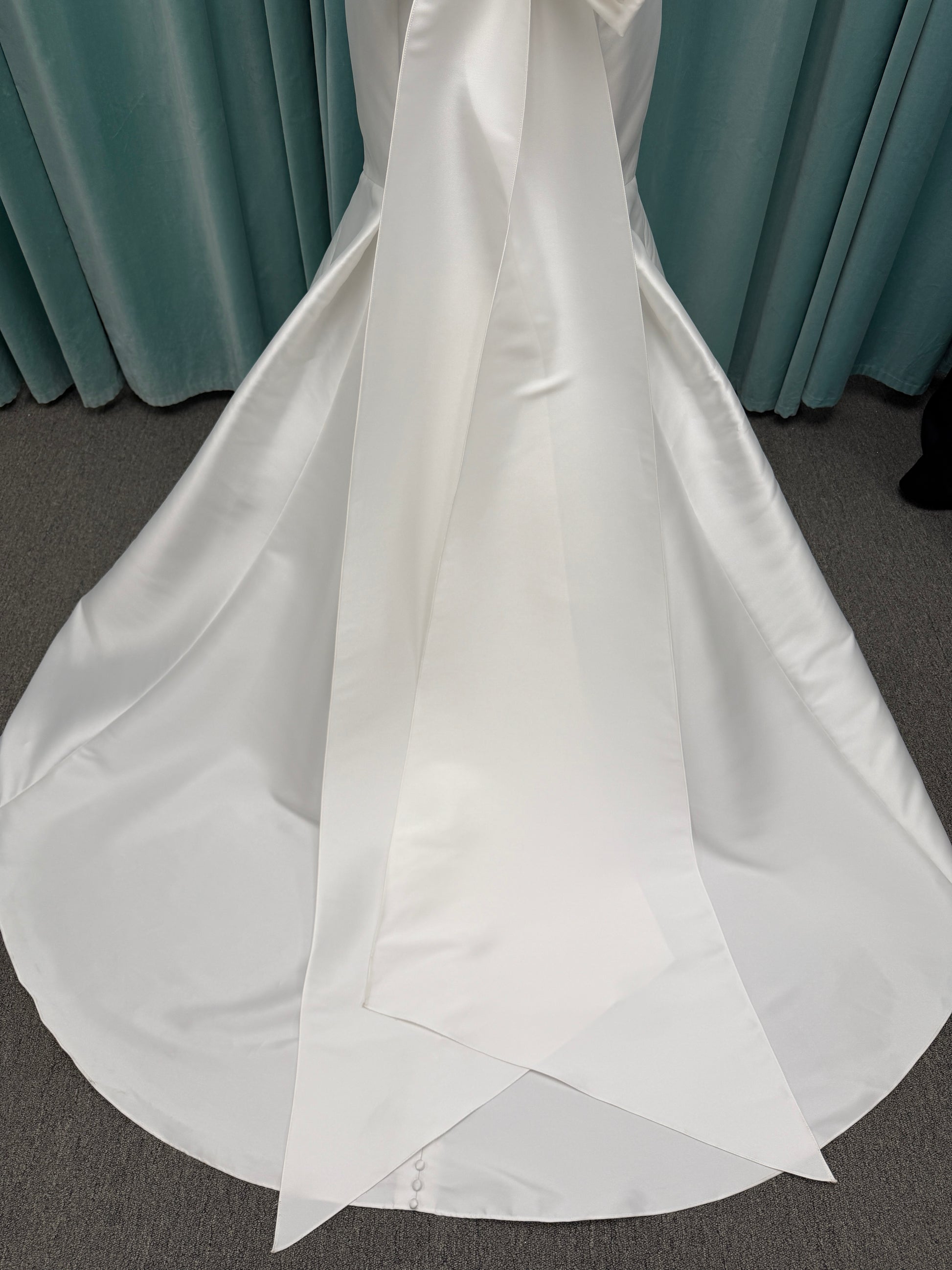 Modest Mikado fit-and-flare wedding dress with square neckline, low scoop back, and dramatic detachable bow train