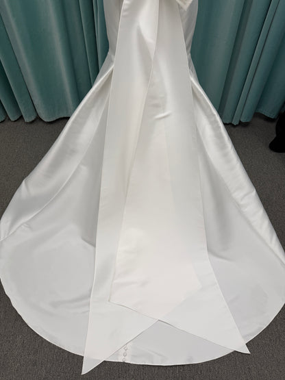 Modest Mikado fit-and-flare wedding dress with square neckline, low scoop back, and dramatic detachable bow train