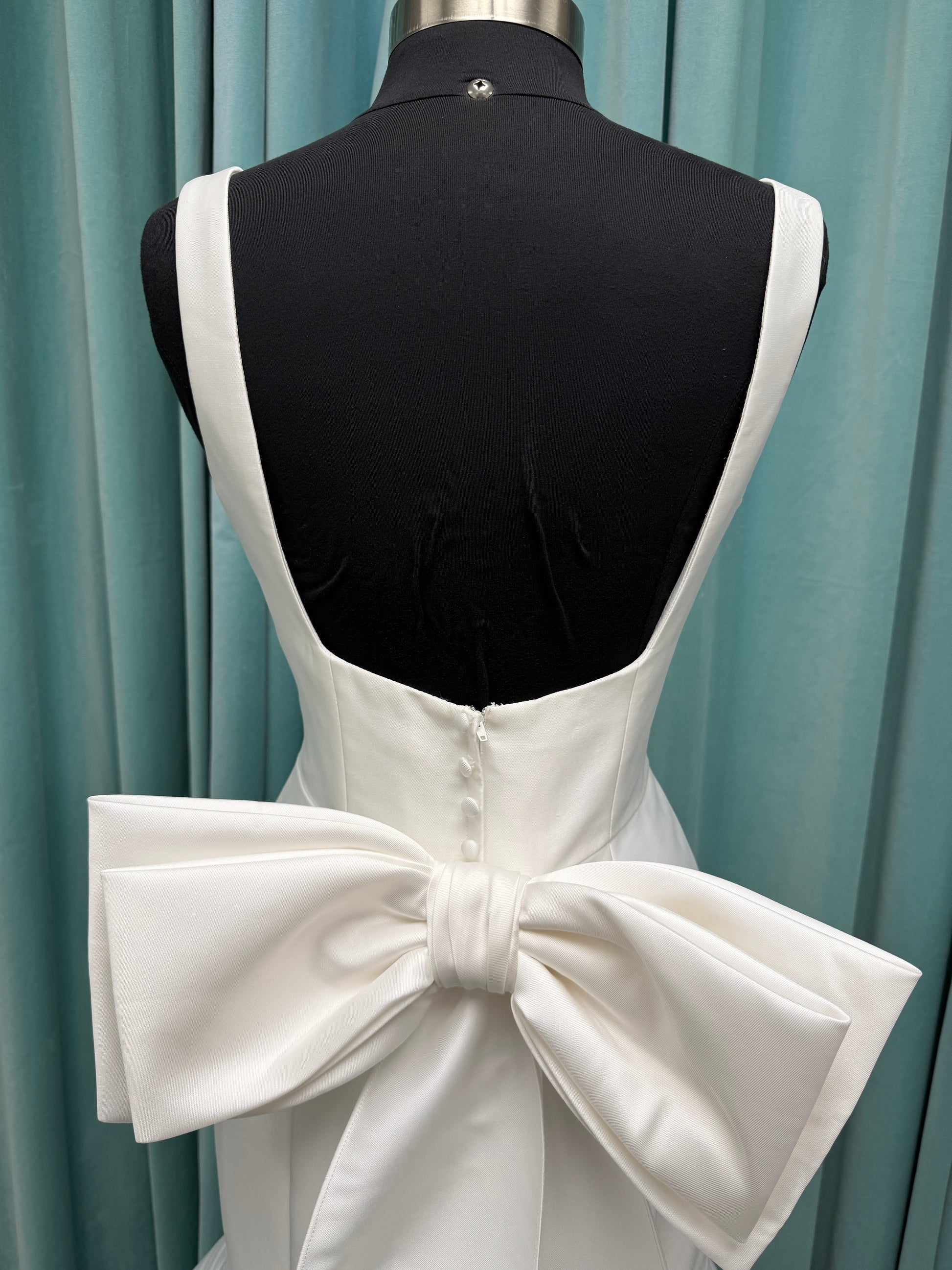 Modest Mikado fit-and-flare wedding dress with square neckline, low scoop back, and dramatic detachable bow train