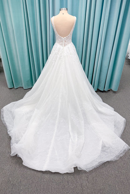 Morilee 1010021 Myrtha A-line wedding dress on mannequin with plunging V-neckline, sheer low scoop back, and glitter tulle lace applique