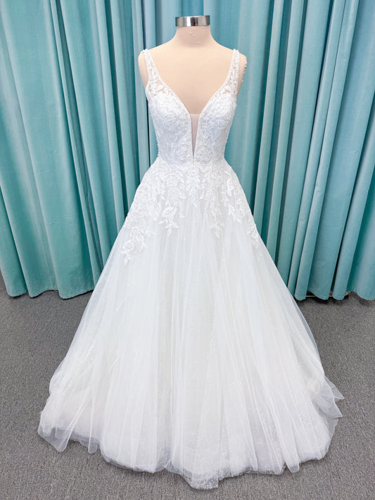 Morilee 1010021 Myrtha A-line wedding dress on mannequin with plunging V-neckline, sheer low scoop back, and glitter tulle lace applique