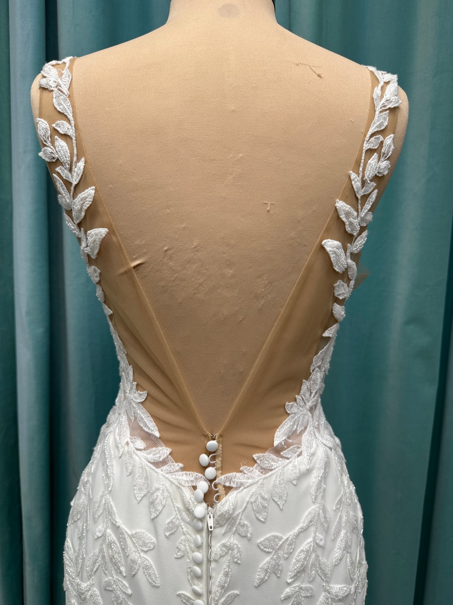 Essense of Australia D4037 crepe sheath wedding dress with plunging V-neckline, sheer lace bodice, side cutouts, and low back with lace train