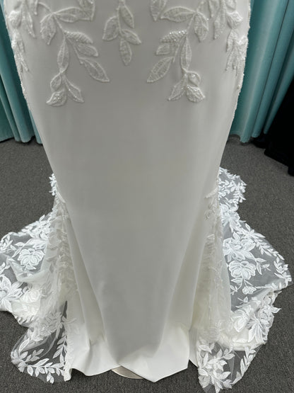 Essense of Australia D4037 crepe sheath wedding dress with plunging V-neckline, sheer lace bodice, side cutouts, and low back with lace train