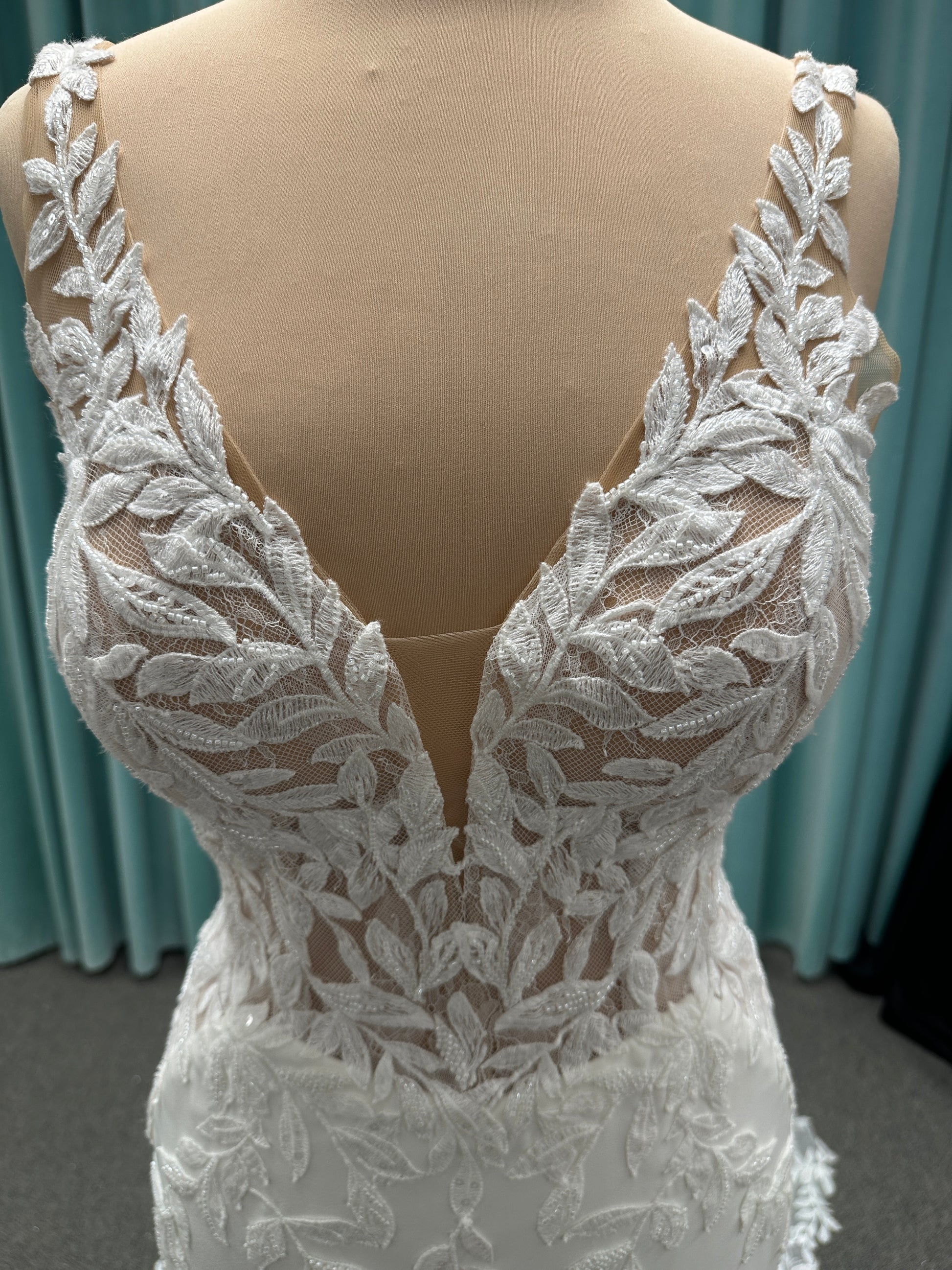 Essense of Australia D4037 crepe sheath wedding dress with plunging V-neckline, sheer lace bodice, side cutouts, and low back with lace train