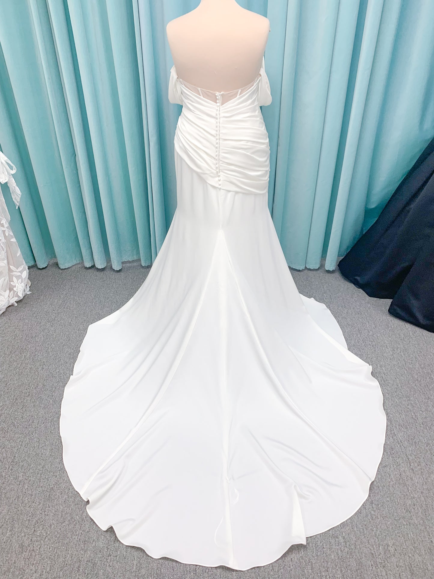 Morilee 4473 Reba plus size A-line wedding dress in Larissa satin with cowl strapless neck, detachable organza bow tie straps, and covered buttons to hem.