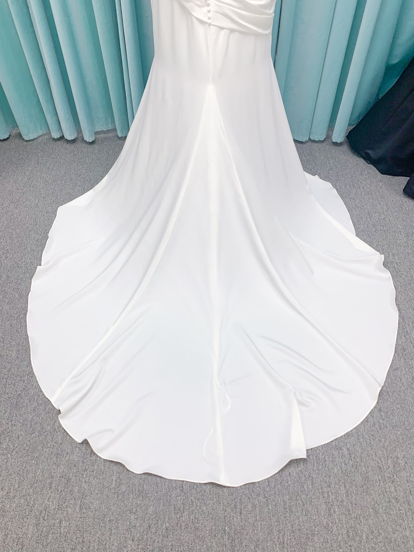 Morilee 4473 Reba plus size A-line wedding dress in Larissa satin with cowl strapless neck, detachable organza bow tie straps, and covered buttons to hem.