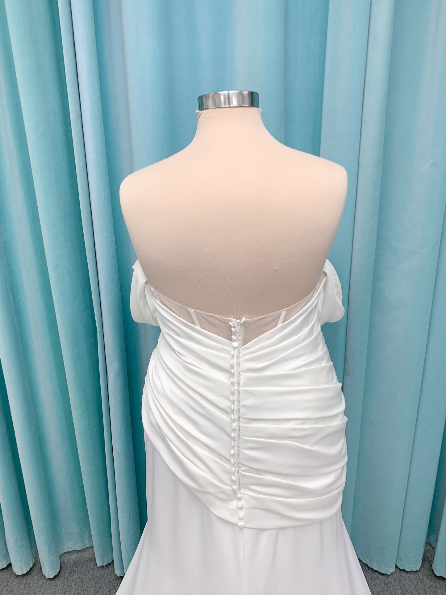 Morilee 4473 Reba plus size A-line wedding dress in Larissa satin with cowl strapless neck, detachable organza bow tie straps, and covered buttons to hem.