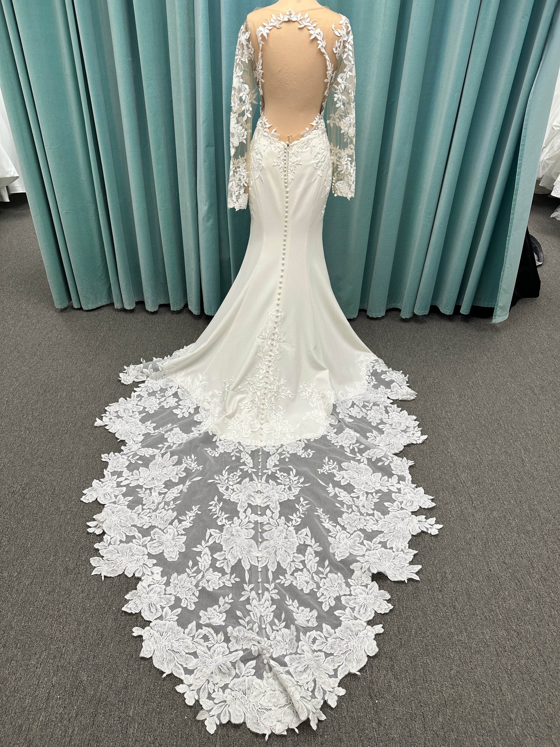 Long sleeve lace wedding dress with sheer illusion bodice and fitted skirt, featuring intricate floral lace and a soft train by Essense of Australia Style D3379