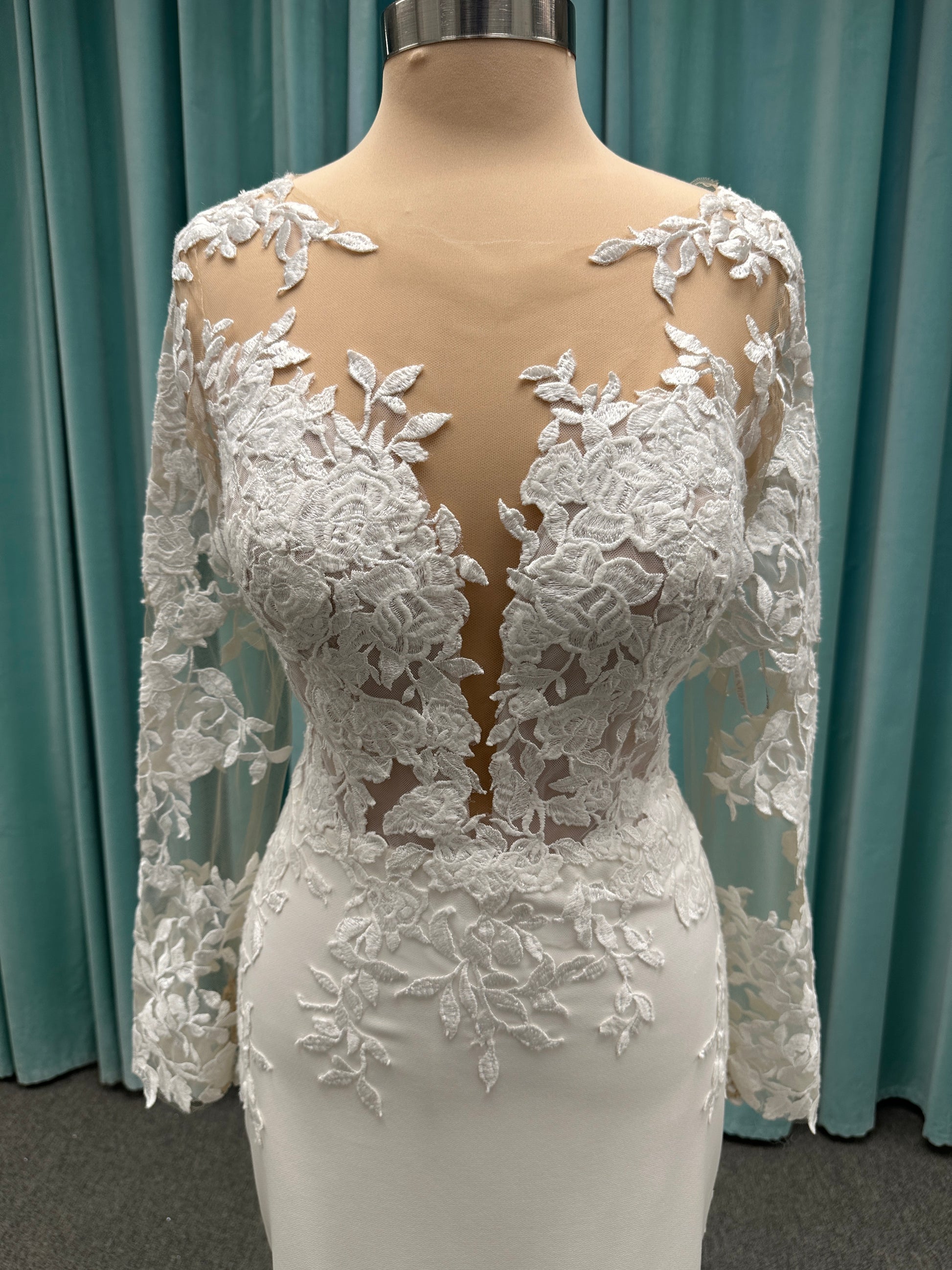 Long sleeve lace wedding dress with sheer illusion bodice and fitted skirt, featuring intricate floral lace and a soft train by Essense of Australia Style D3379