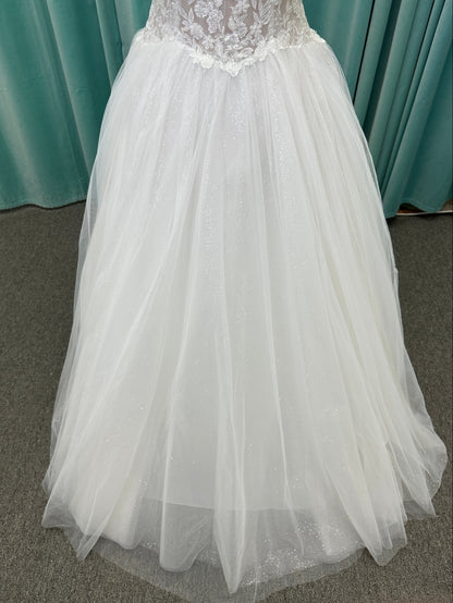 Paige ivory strapless sweetheart A-line wedding dress on mannequin with lace and tulle skirt.
